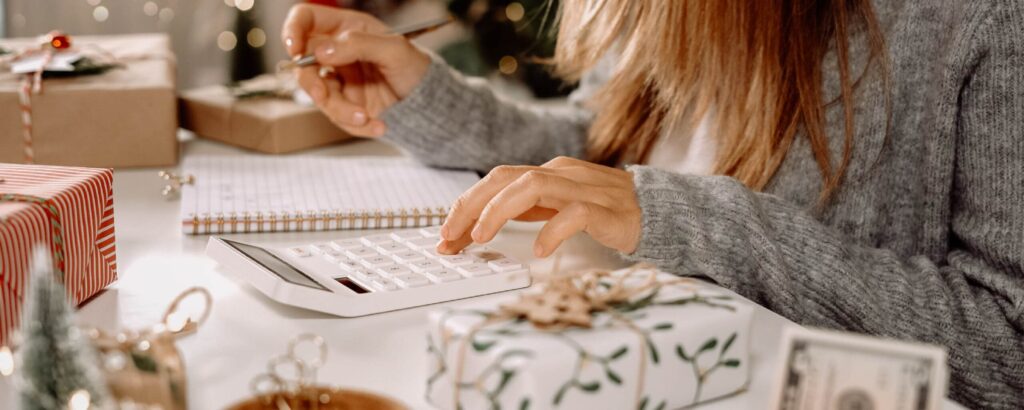 women getting financially ready for Christmas by working out her Christmas budget. 