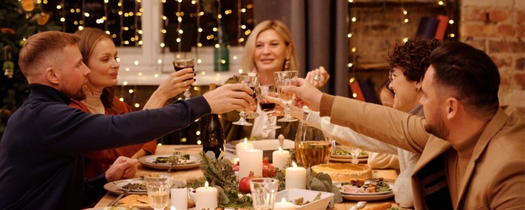 Family and friends cheersing to a Happy Christmas which they got financially ready for before hand because it's the most expensive part of the holiday.